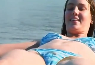 Lickerish brunette babe glowing a hairy cunt on transmitted to beach